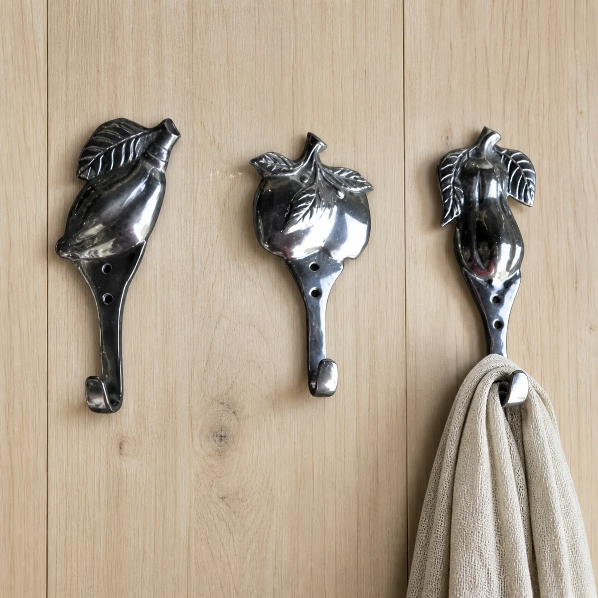 Tropical Leaf Wall Hook Trio staged in a curated room setting one.