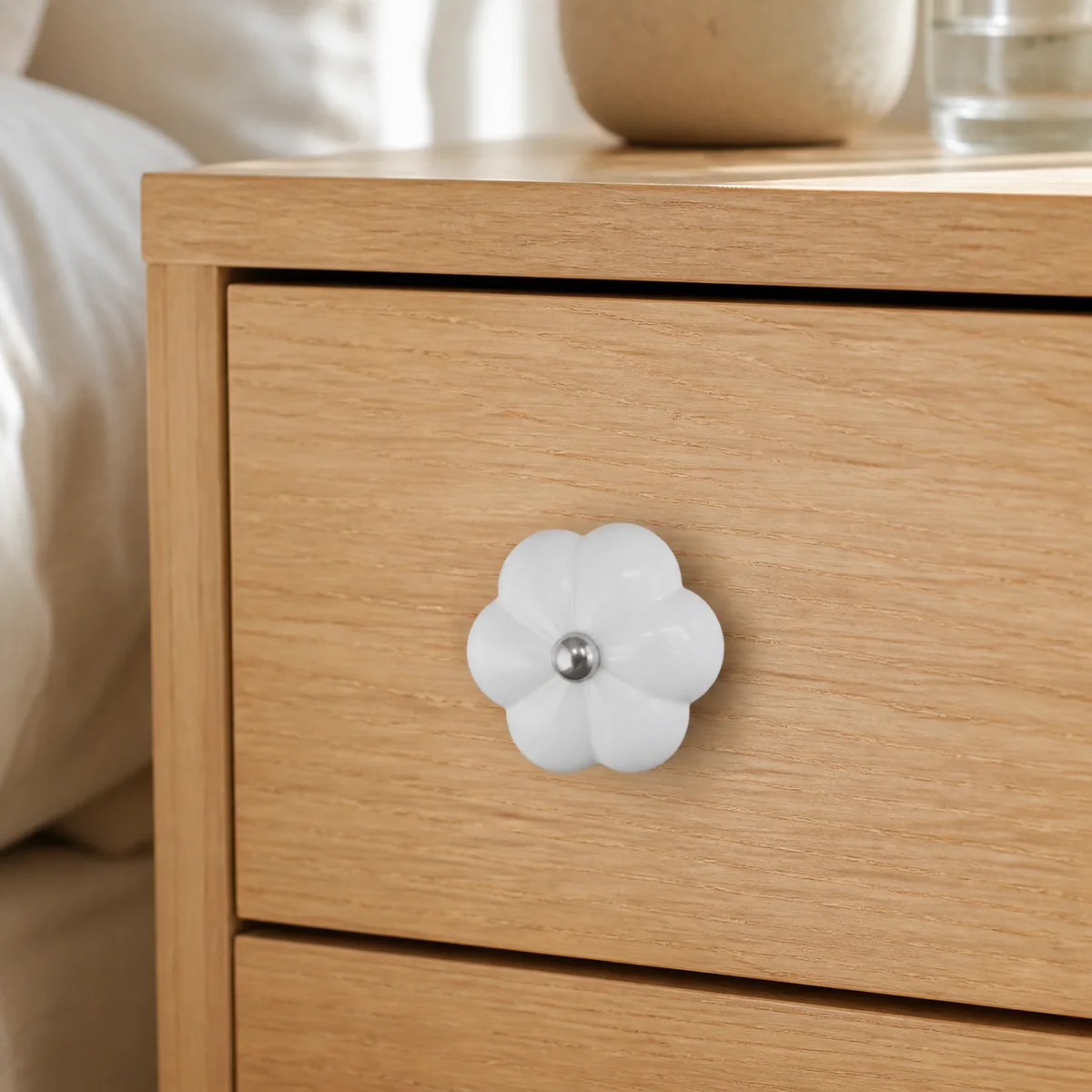 White Petal Ceramic Cabinet Knob staged in a curated room setting one.