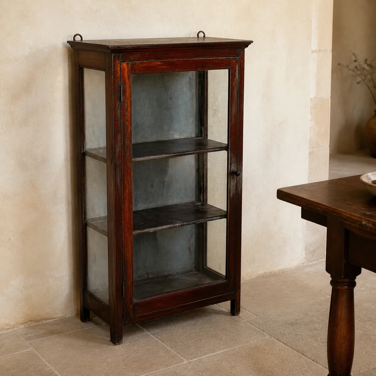 Otjozondjupa Glass Display Cabinet staged in a curated room setting one.