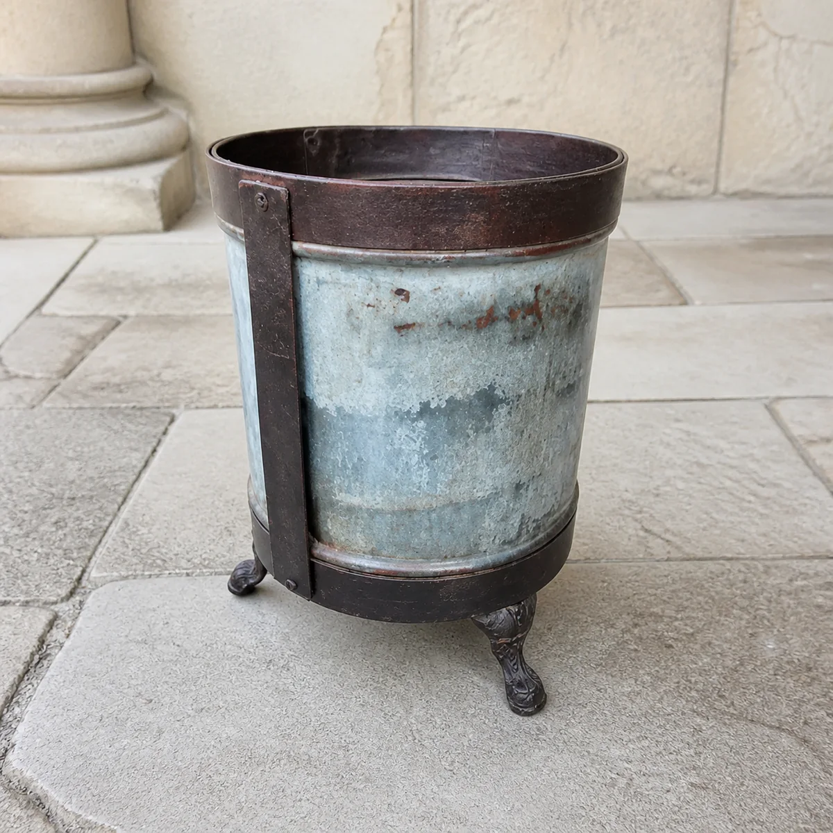 Vintage Footed Galvanised Planter staged in a curated room setting one.