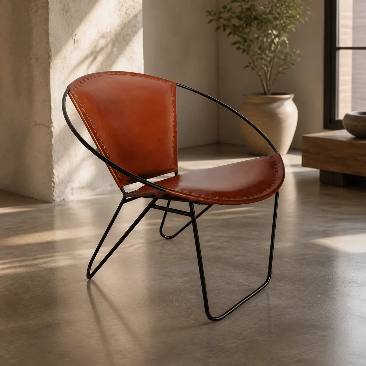 Sundowner Leather Sling Chair staged in a curated room setting one.