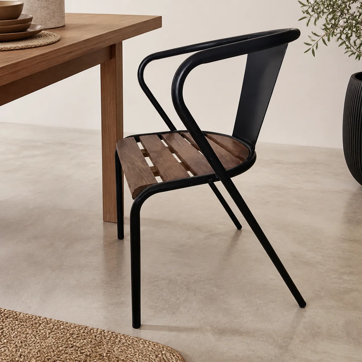 Mopane Slat-Seat Armchair staged in a curated room setting one.