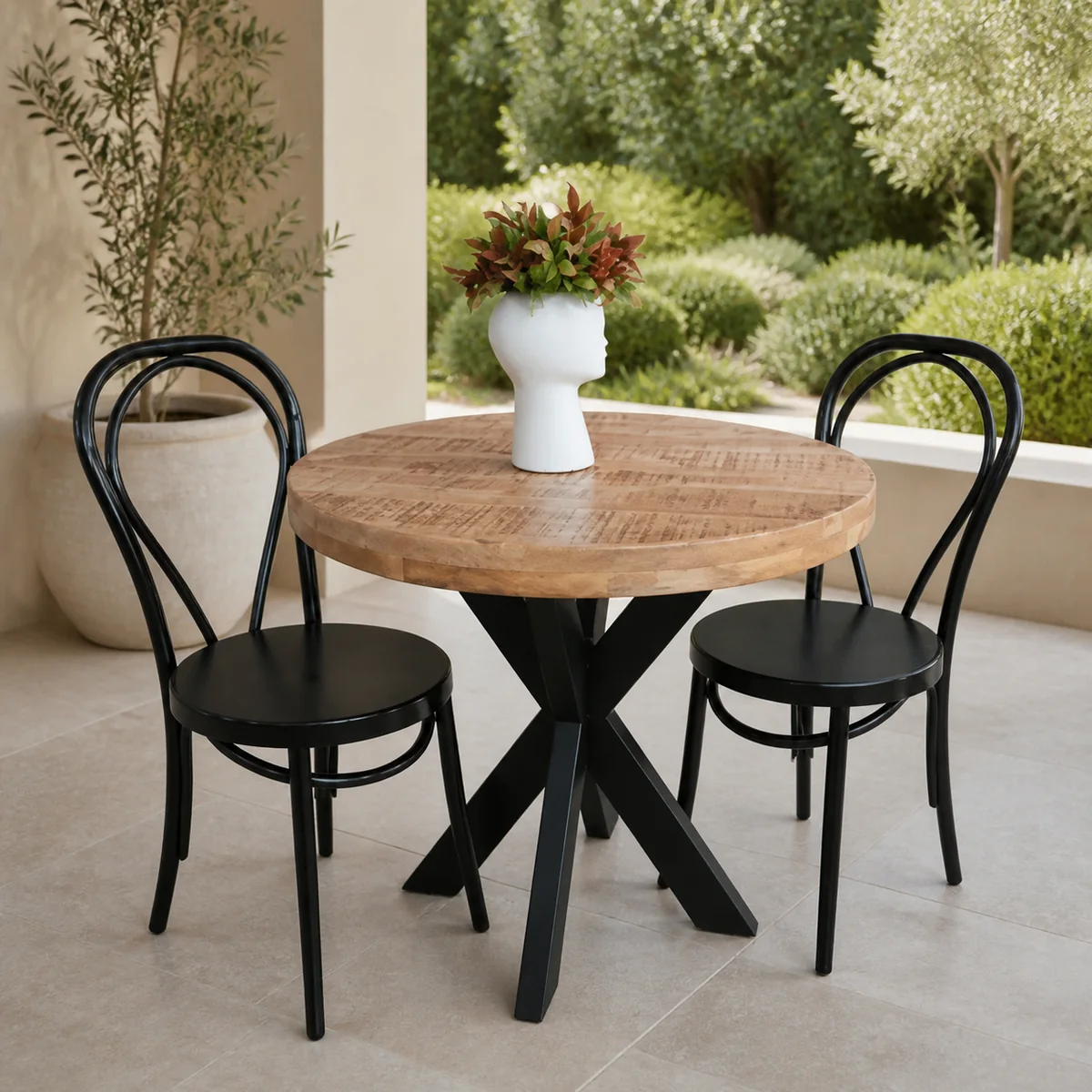 Oasis Round Café Dining Set staged in a curated room setting one.