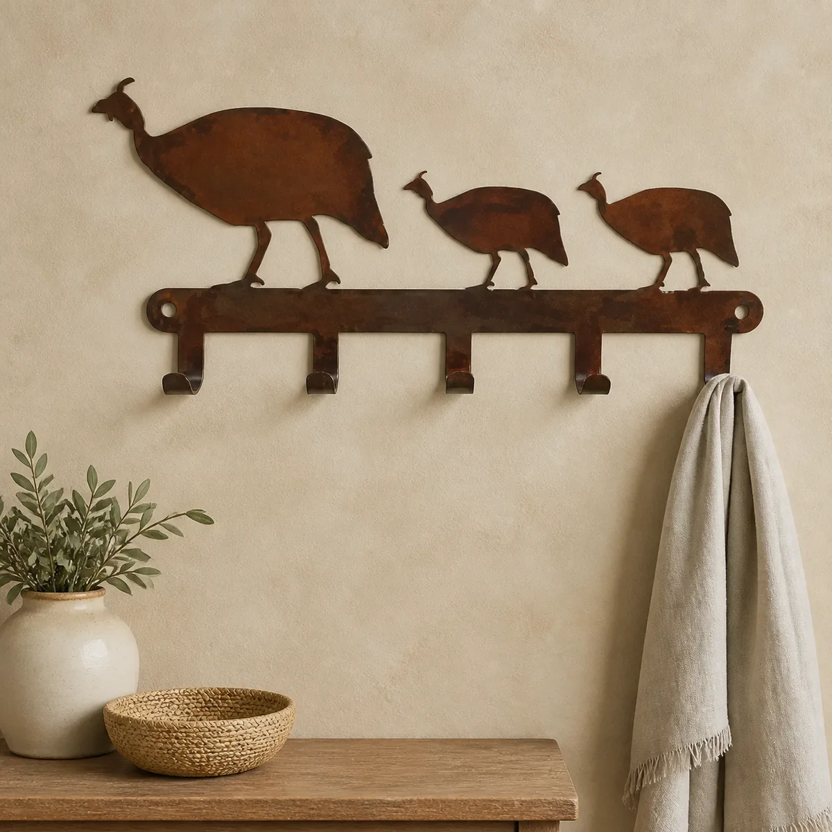Guinea Fowl Four-Hook Rail staged in a curated room setting one.