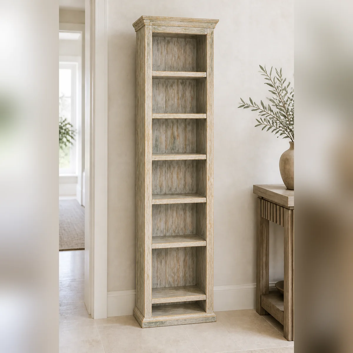 Kunene Slim Greywash Bookcase staged in a curated room setting one.