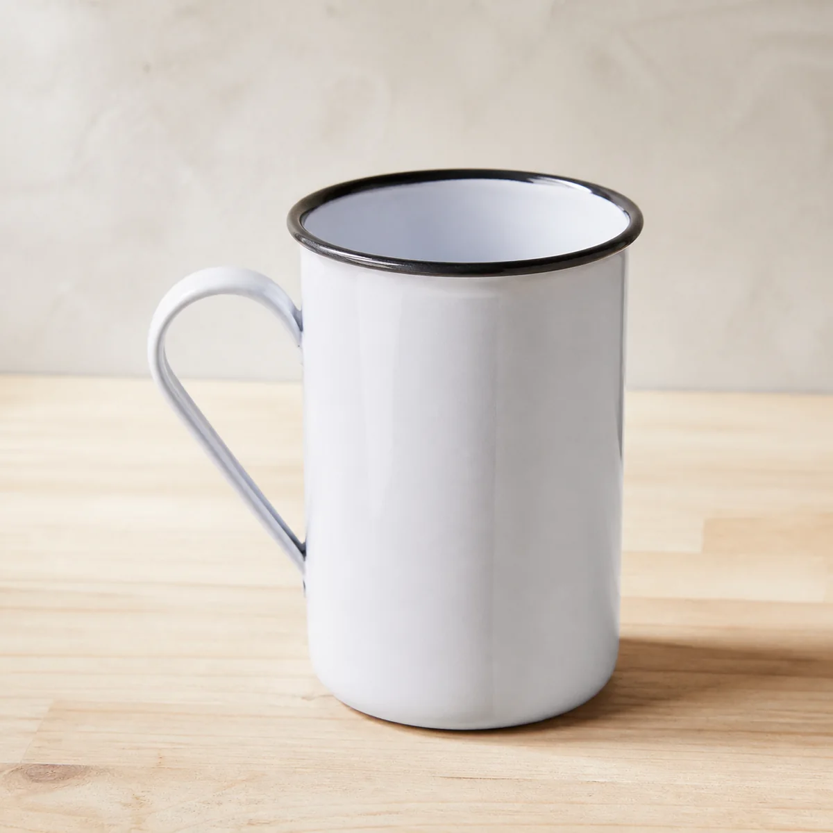 Grey Enamel Camp Mug staged in a curated room setting one.