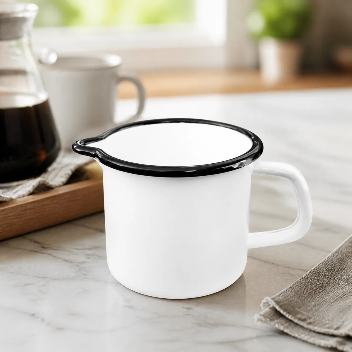White Enamel Creamer staged in a curated room setting one.