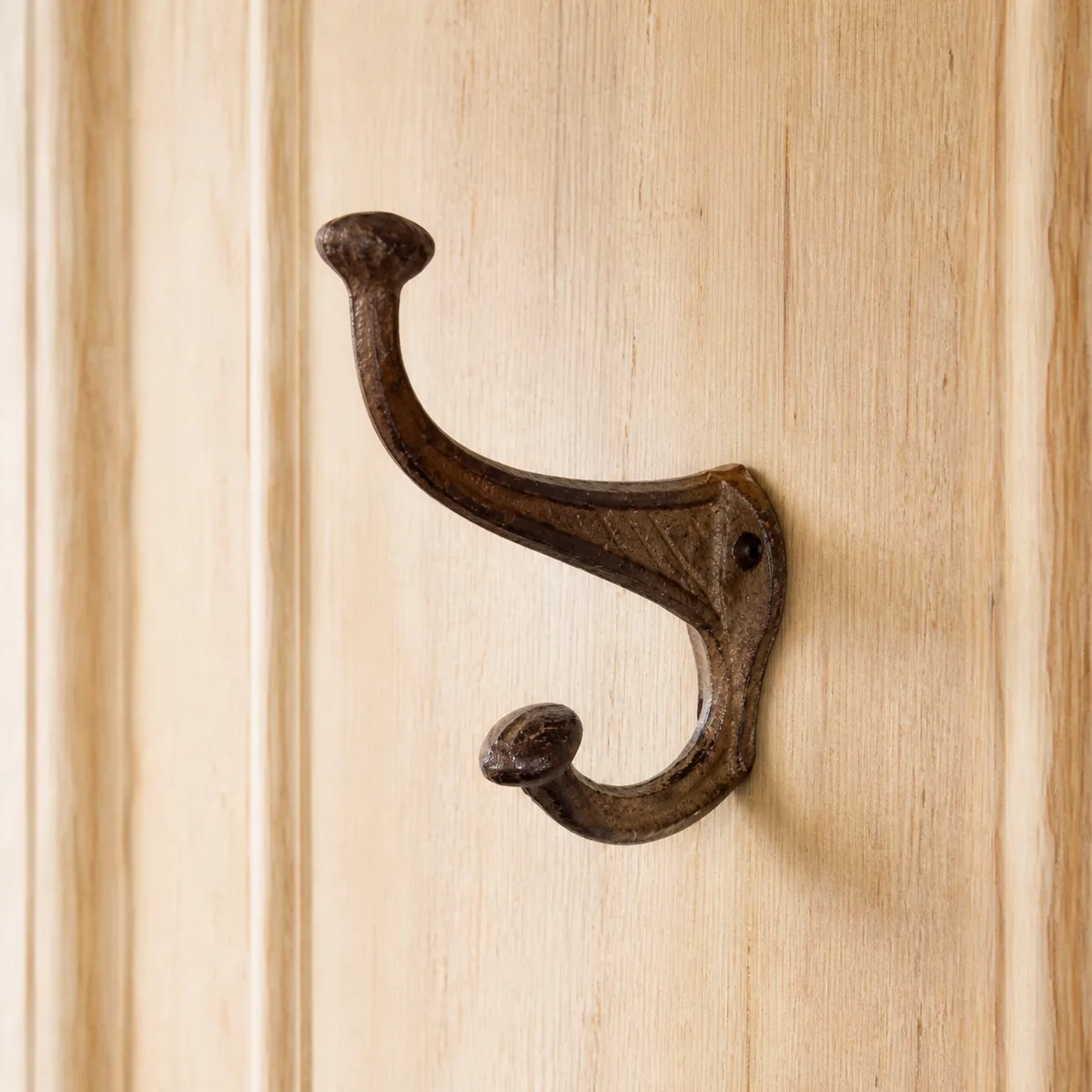 Rust Long-Neck Double Hook staged in a curated room setting one.