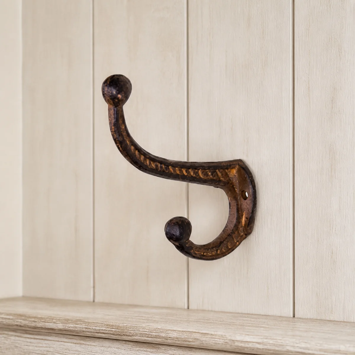Rust Compact Double Hook staged in a curated room setting one.