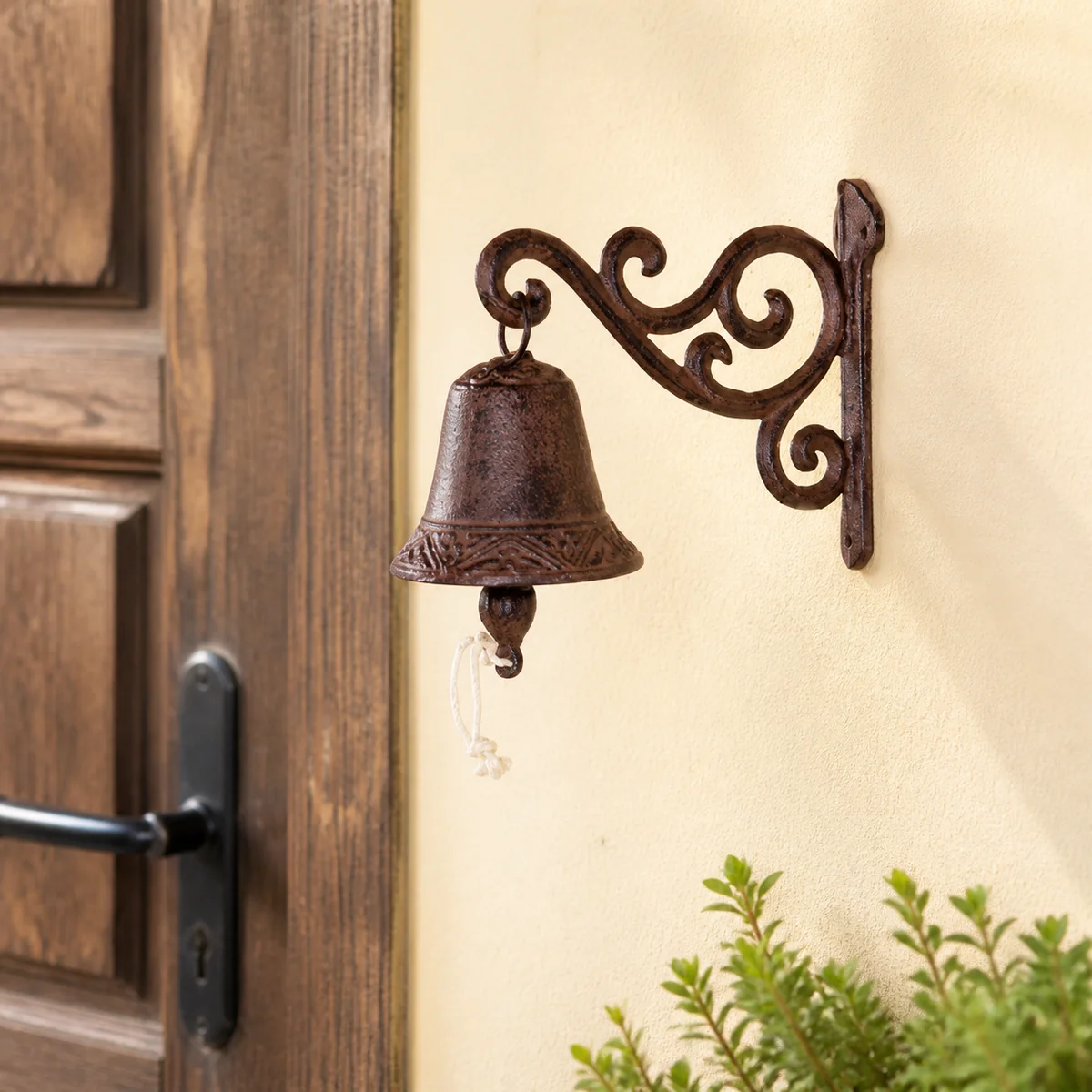 Antique Rust Scroll-Bracket Bell staged in a curated room setting one.
