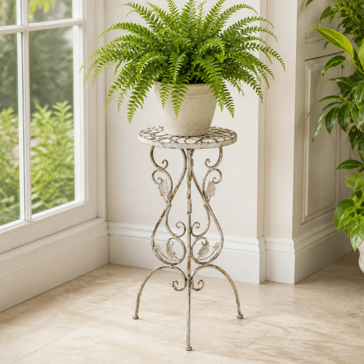 Ivory Scroll Plant Stand staged in a curated room setting one.
