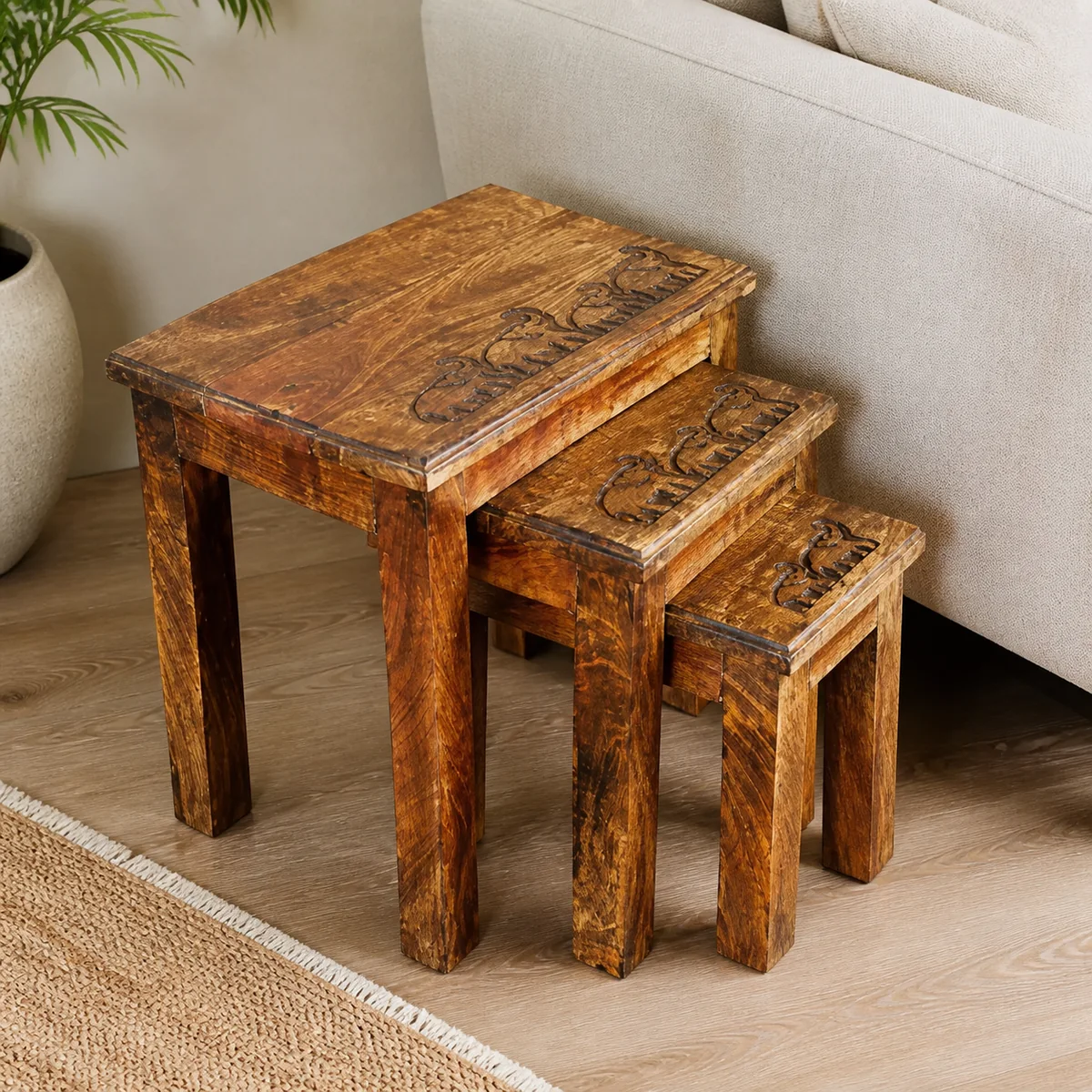 Elephant Procession Nesting Tables staged in a curated room setting one.